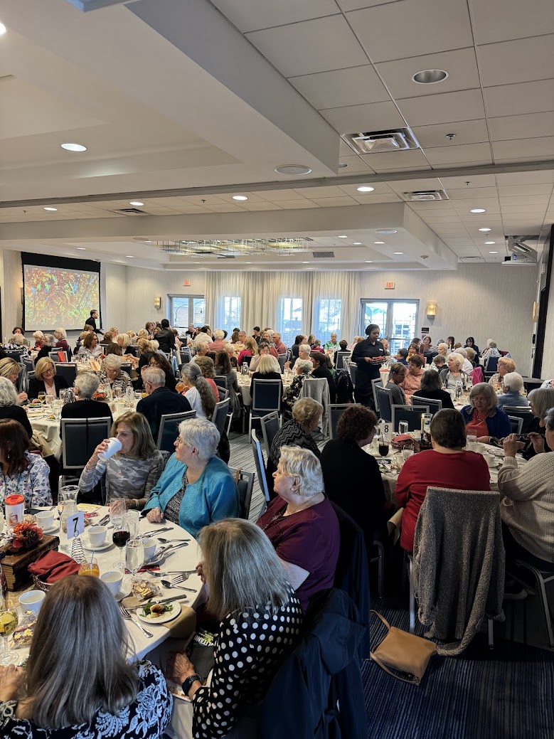 People dining at round tables in hotel banquet room