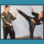 Tom and Bob Varasconi from Varasconi’s School of Self Defense: Branch of Hamzy’s in Bristol sparring on a teal background.