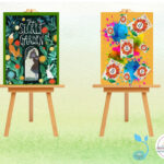 Two art works showcasing book cover art on easels.