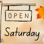 An Open Saturday Sign with a Leaf