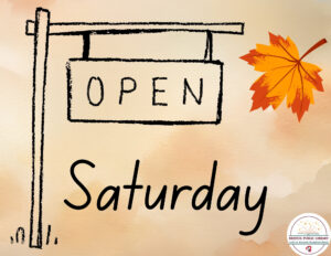 An Open Saturday sign with a fall leaf
